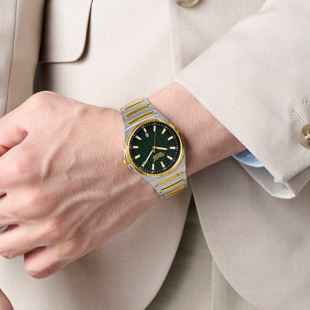 Gold and silver watch on a person wearing a beige suit.